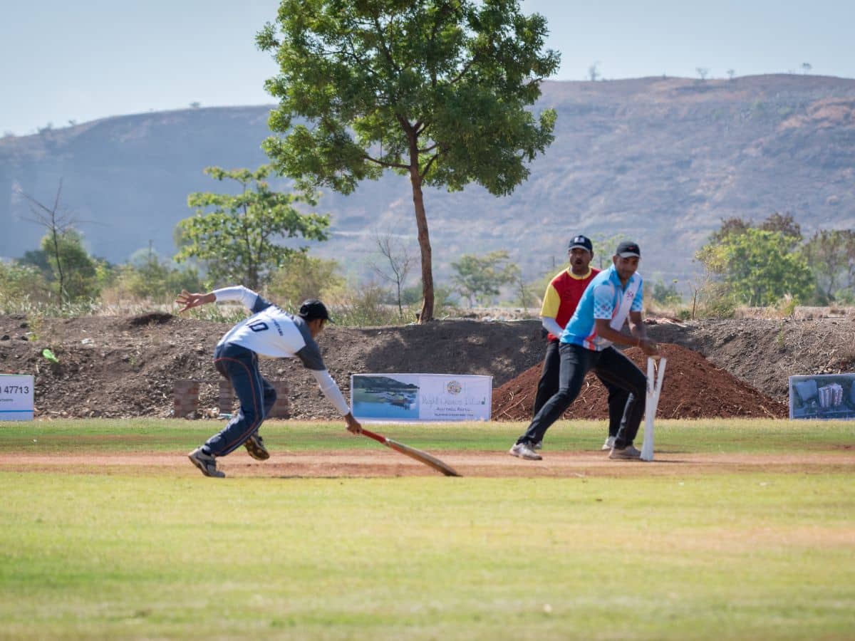 Batter taking a run during an Academy match